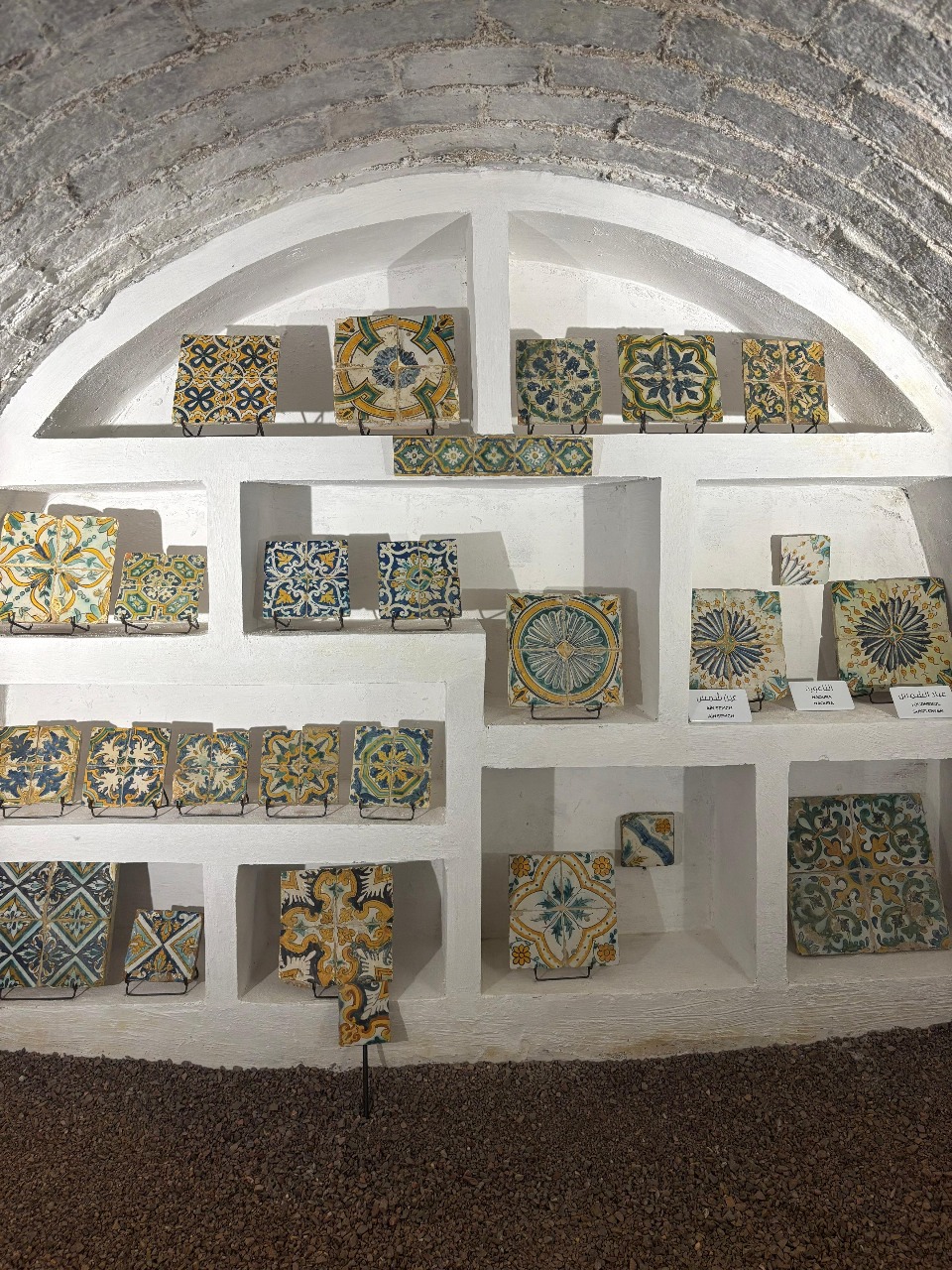 Antique Tunisian ceramic tiles displayed in the Dehliz El Zliz basement gallery at Dar Ben Gacem Kahia